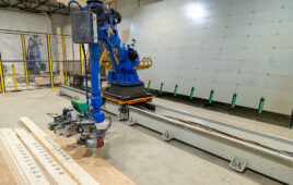 Reframe robotic arm picking up a board.