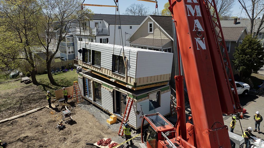 A crane placing part of Reframe's homes.