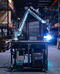 A UR8 Long robot arm in a Hirebotics welding cell.