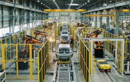 AI generated image of a production line with industrial robot workcells surrounded by guarding fences.