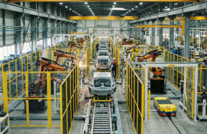 AI generated image of a production line with industrial robot workcells surrounded by guarding fences.