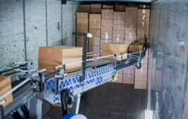 Bastian Solutions' ULTRA BLUE robot reaches into a trailer.