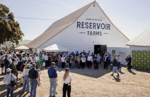 a crowd gathers in front of the Reservoir Farms barn.