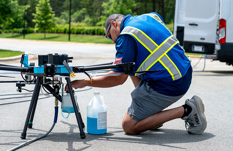 an operator reloads cleaning solution.