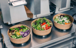 Three bowls of dispensed salad.