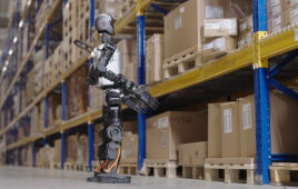 image of a humanoid robot looking up at shelves in a warehouse.