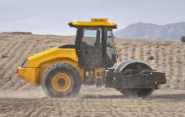 hero image of a compactor on a dirt road with no operator in the cab.