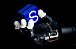 A robot hand holding a block.