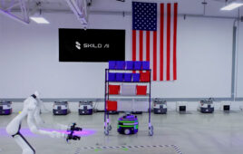 image of a humanoid and mobile robots on a warehouse floor.