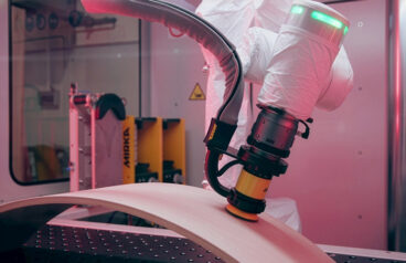 An ABB collaborative robot sanding an object.