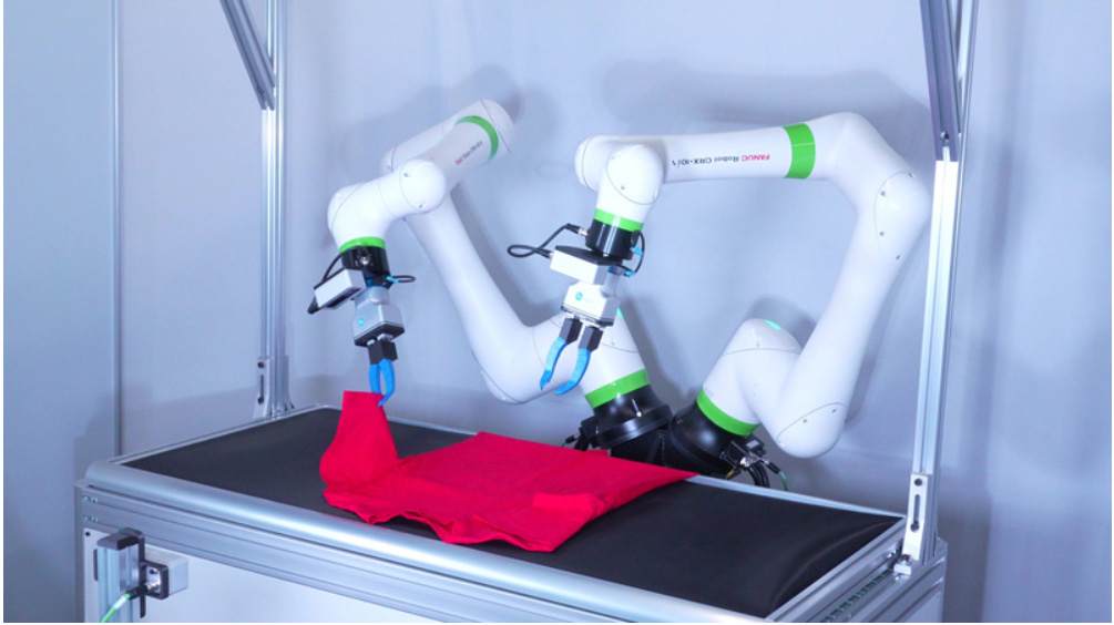 A dual-armed robot uses imitation learning to fold T-shirts with FANUC and NVIDIA technology.