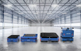 lineup of ANSCER robots in an empty warehouse building.