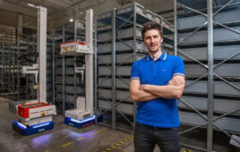 Jan Zizka standing in front of 2 Brightpick robots.