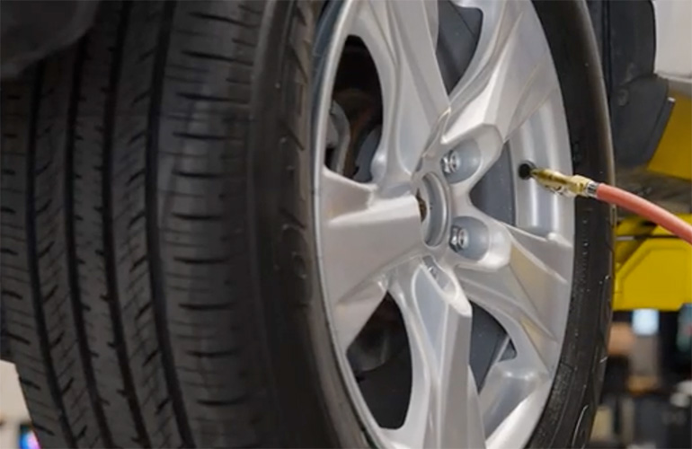 close up of air hose attached to a tire.