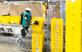 A Digit robot from Agility stacking a yellow crate.
