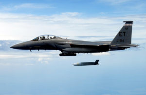 lockheed martin jet over the ocean deploying a missile.