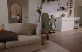 the weave issac-1 robot at rest in a living room scene.