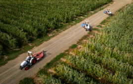 agtonomy tractors shown from a drone shot, turning around on a narrow dirt path between fields.