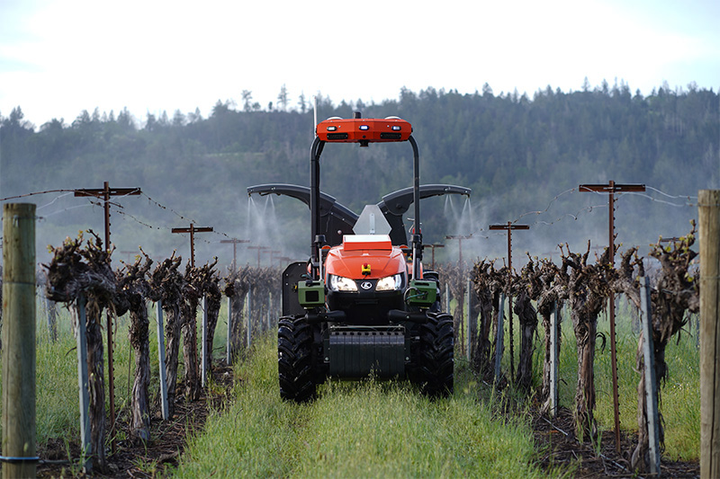 agtonomy equipped bobcat tractor in front of a vineyard. AI promises to make equipment safer, more autonomous, and more productive.