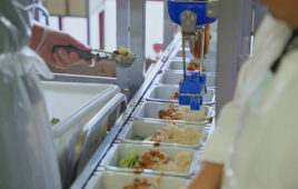 Chef Robotics' robot picking up food.