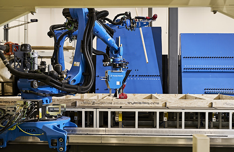 A robot arm assembling a house component. Promise Robotics says it can accelerate homebuilding by standardizing component manufacturing.