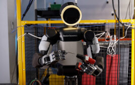 Boston Dynamics' Atlas robot putting a drill bit into a drill.