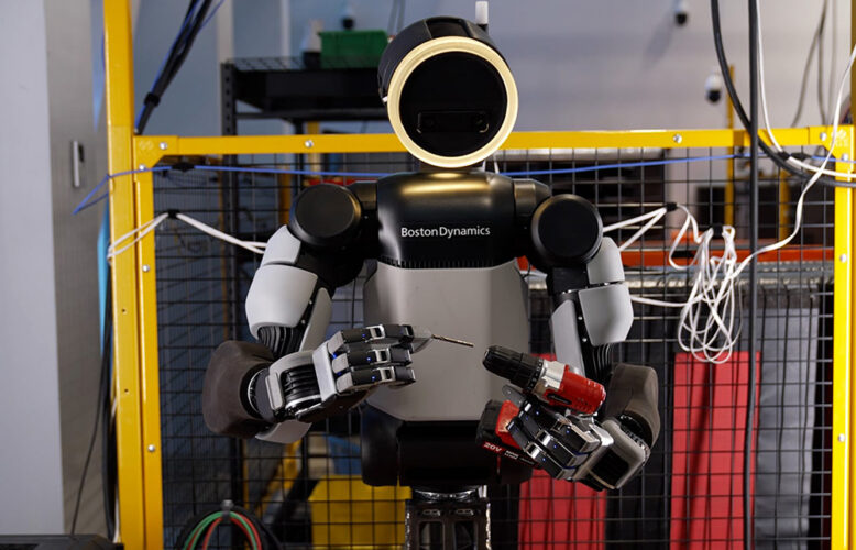Boston Dynamics' Atlas robot putting a drill bit into a drill.
