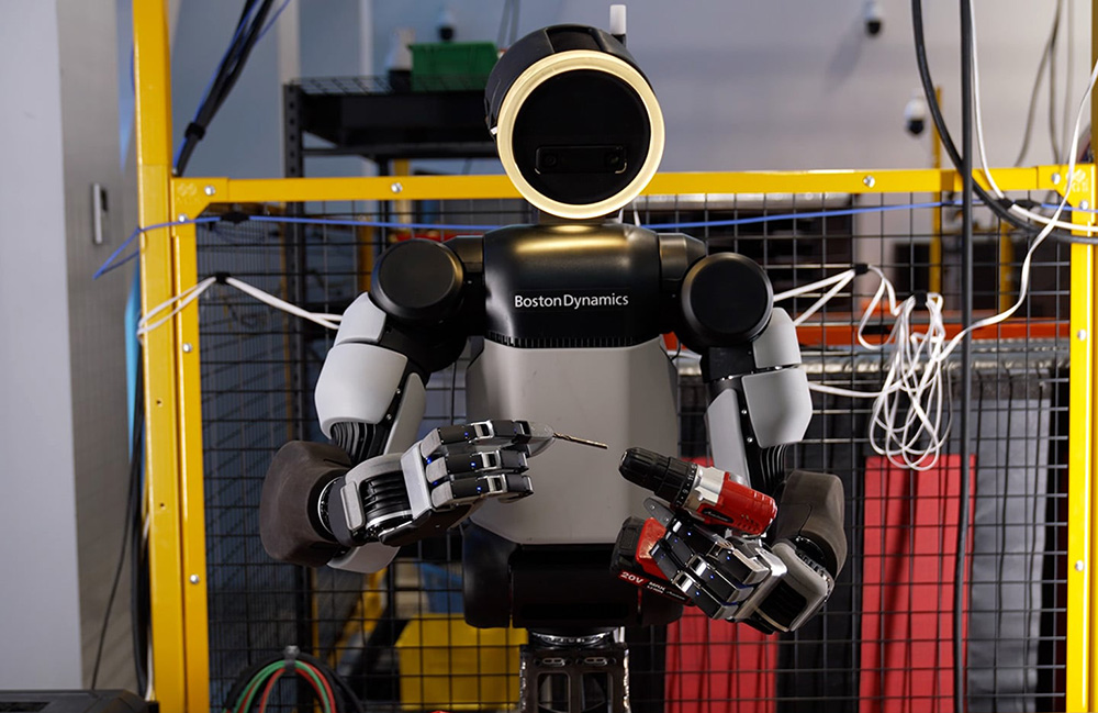 Boston Dynamics' Atlas robot putting a drill bit into a drill.