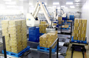 A robot arm palletizing packages.
