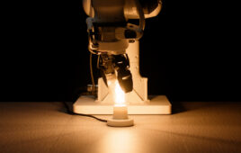 A robotic arm screwing in a lightbulb.