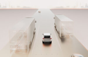 An image of a car driving on a simulated road next to simulated trucks.