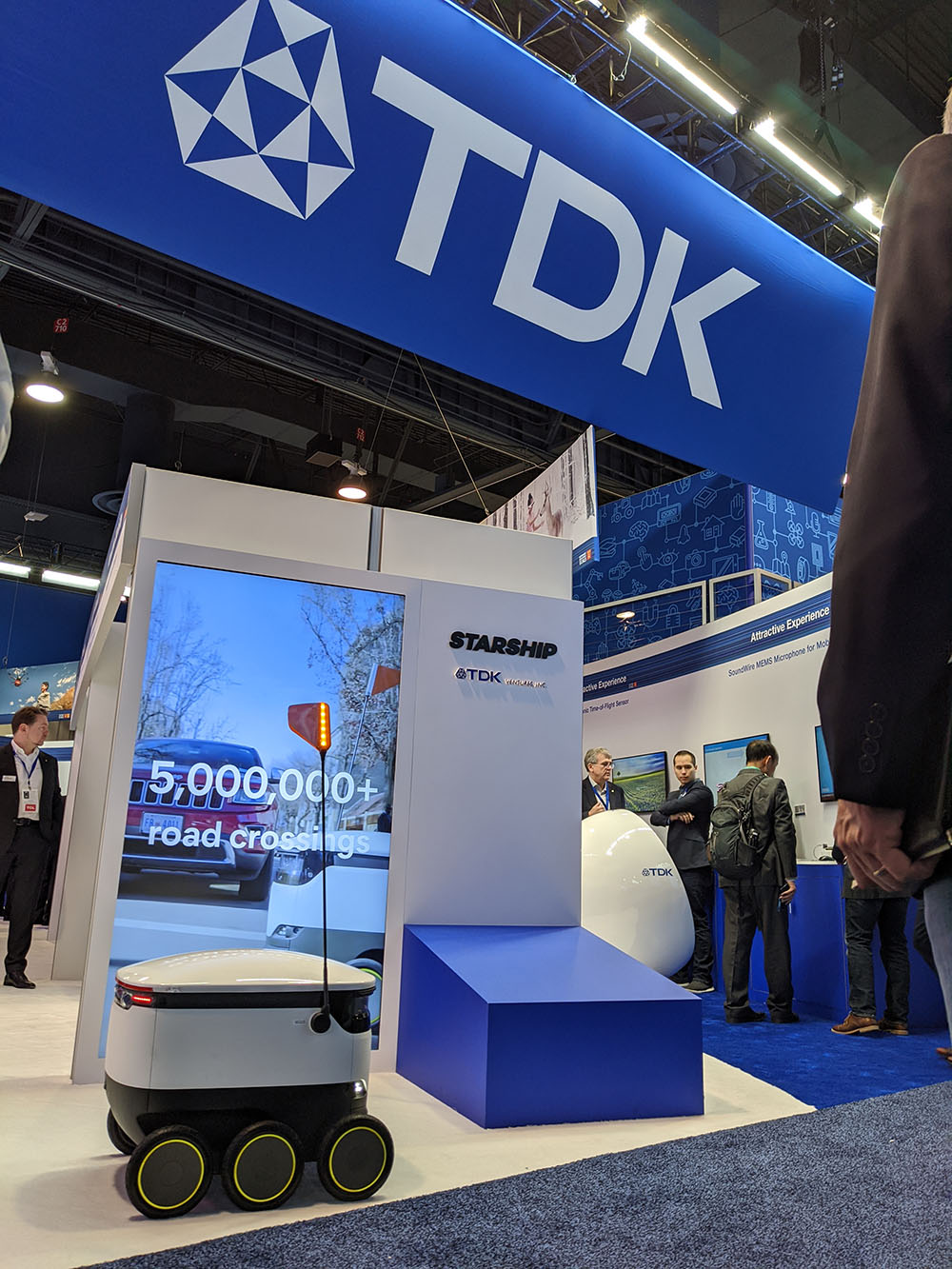 TDK Ventures booth at a tradeshow, prominently featuring a Starship robot. The investor has also supported human-like dexterity.